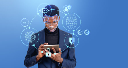 Portrait of serious young African American businessman using tablet computer with immersive...