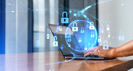 Unrecognizable man hands typing on laptop in blurry office with double exposure of cybersecurity...