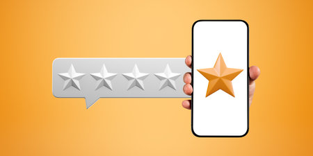 Hand of unrecognizable man showing smartphone with five star rating over orange background. Concept...
