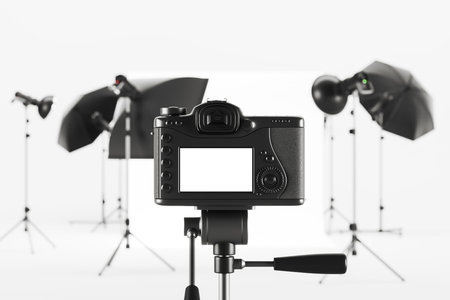 Photo camera and studio room with professional equipment and cyclorama, mock up blank display. Concept of shooting, tv, show and film production. 3D rendering illustrationの写真素材