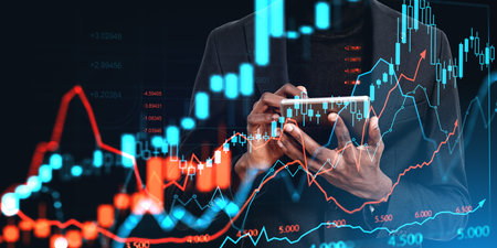 African businessman hands working in tablet, double exposure forex diagrams and candlesticks. Stock...