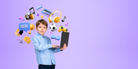 Serious little boy kid holding laptop standing over purple background with online entertainment and...