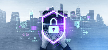 Top view of businessman hands using laptop with double exposure of immersive cybersecurity shield...