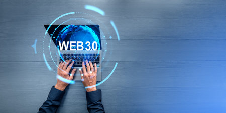 Top view of businessman hands typing on laptop at table with double exposure of immersive web 3.0 interface. Concept of new generation of internet and metaverse, cutting edge technology. copy spaceの写真素材