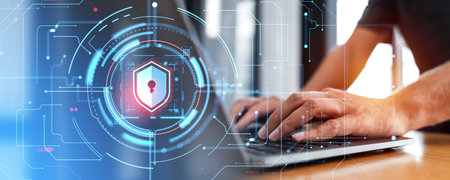 Hands of unrecognizable businessman typing on laptop keyboard at office table with double exposure of cyber security shield HUD interface. Concept of data leakage and prevention of privacy in cyberspaceの写真素材