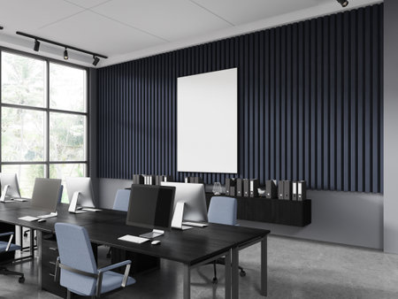 Corner of stylish open space office with blue and gray walls, concrete floor, row of computer tables...