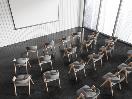 Top view of office meeting interior with armchairs in row, mock up copy space projection screen on wall. Training or learning space with panoramic window on skyscrapers. 3D renderingの写真素材