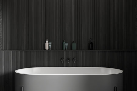 Interior of stylish bathroom with dark wooden walls, comfortable gray bathtub and shelf with cosmetic products above it. 3d renderingの写真素材