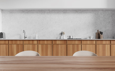 Closeup of cozy home kitchen interior eating table with chairs, cooking cabinet with kitchenware and counter with coffee maker in modern apartment. 3D renderingの写真素材
