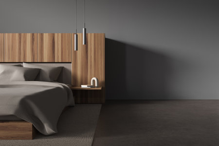 Interior of modern bedroom with gray walls, concrete floor, comfortable king size bed with gray blanket standing on gray carpet and copy space wall on the right. 3d renderingの写真素材