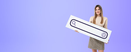 Happy young European woman holding internet search bar sign standing over purple copy space background. Concept of online search, web surfing and internet researchの写真素材