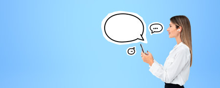 Beautiful young woman profile typing in smartphone, mock up empty chat bubble, wearing earbuds. Copy...