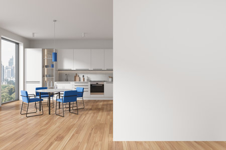 Interior of modern kitchen with white walls, wooden floor, cozy white cupboards and cabinets, round dining table with blue chairs and copy space wall on the right. 3d renderingの写真素材