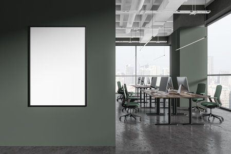 Stylish green coworking interior with chairs, desk with pc computers on gray concrete floor. Panoramic window on Singapore skyscrapers. Mock up canvas poster on partition. 3D renderingの写真素材