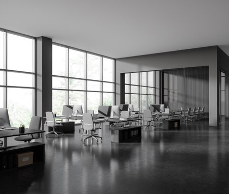 Corner of stylish open space office with gray and wooden walls, concrete floor, rows of computer desks with gray chairs and glass wall meeting room in background. 3d renderingの写真素材