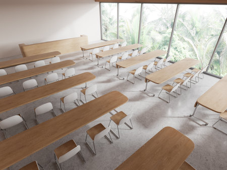 Top view of modern college classroom interior with white walls, concrete floor, rows of long tables and white chairs. 3d renderingの写真素材