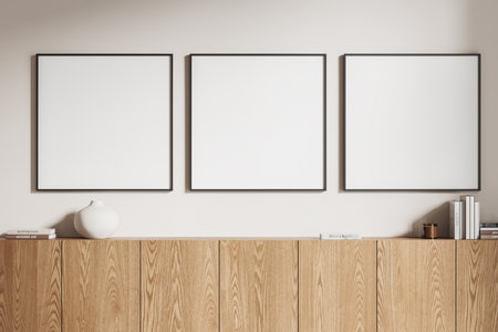 Stylish home living room interior with wooden sideboard, minimalist art decoration and books. Three mock up square canvas posters in row on white wall. 3D renderingの写真素材
