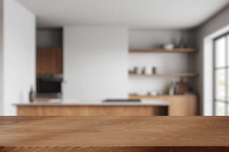 Wooden table on blurred background of cozy white kitchen interior, home cooking space with bar island, sink and stove. Mock up copy space for product display. 3D renderingの写真素材