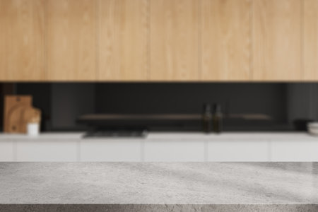 Empty stone table on blurred background of stylish home kitchen interior, cooking space with kitchenware and stove. Mock up copy space for product display. 3D renderingの写真素材