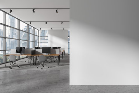 Interior of modern open space office with white walls, carpeted floor and rows of computer desks with gray chairs standing near panoramic window with cityscape. Copy space wall. 3d renderingの写真素材