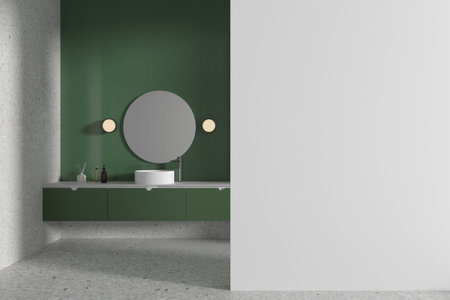 Interior of modern bathroom with green and white walls, concrete floor, comfortable white sink standing on green counter and round mirror. Copy space wall on the right. 3d renderingの写真素材