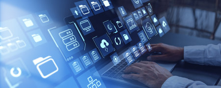 Hands of businessman using laptop with immersive big data interface at blurry office table. Concept...