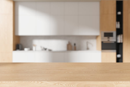 Empty wooden table on blurred background of stylish home kitchen interior, cooking space with cabinet and kitchenware. Mock up copy space for product display. 3D renderingの写真素材