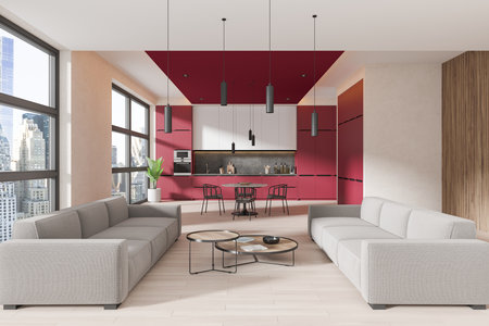 Modern home studio interior with sofa and coffee table, hardwood floor. Cooking space with dining...