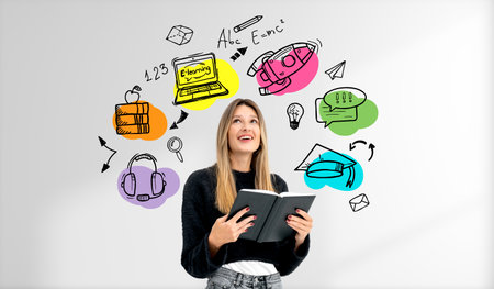 Dreaming woman student with notebook in hands, looking up at colorful doodle drawing of educational...