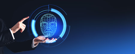 A person interacting with a virtual face recognition interface on a dark blue background, depicting...