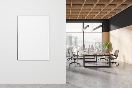A modern office interior with a blank poster on the wall, wood elements, and city view through large windows. 3D Renderingの写真素材
