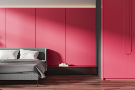 Colored home bedroom interior bed with gray linens, black nightstand with books on hardwood floor. Red sleep room with wardrobe and minimalist decoration. 3D renderingの写真素材