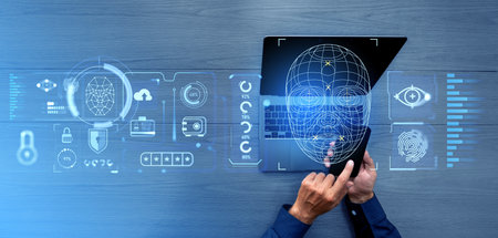 Businessman using laptop and finger touch phone, biometric scanning with face id and data protection...