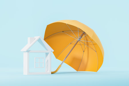 A miniature house model protected by a large yellow umbrella on a light blue background, concept of home insurance and property protection. 3D Rendering.の写真素材