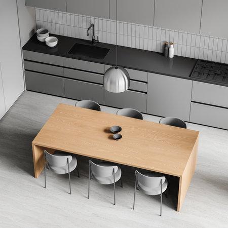 Top view of home kitchen interior with wooden dining table and chairs, gray cooking cabinet with kitchenware on counter. Stylish eating zone in minimalist apartment. 3D renderingの写真素材