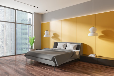 Corner view of home bedroom interior with bed, black drawer with books and lamps, hardwood floor. Yellow sleep room with panoramic window on Singapore. 3D renderingの写真素材