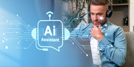 Pensive man using laptop in headphones, AI hologram with chat bot and online communication, circuit lines and connection. Concept of artificial intelligence and virtual assistantの写真素材