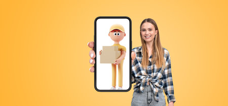Woman holding a smartphone displaying a cartoon delivery person. Yellow background. Concept of online delivery and technology interactionの写真素材