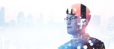 Serious businessman in eyeglasses portrait silhouette, double exposure city skyscrapers on empty white background. Concept of start up, business idea and future planの写真素材