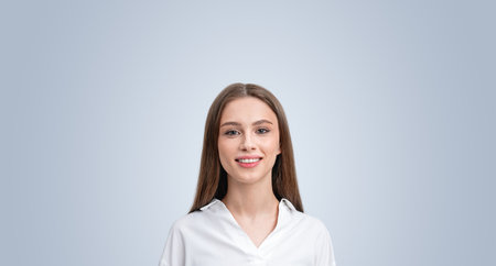 Happy businesswoman student smiling portrait on grey copy space background, looking at the camera. Concept of online network, communication and careerの写真素材