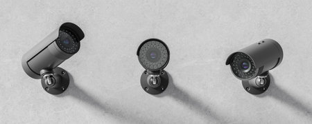 Three CCTV security cameras on stone wall in row, video equipment for safety system area control....