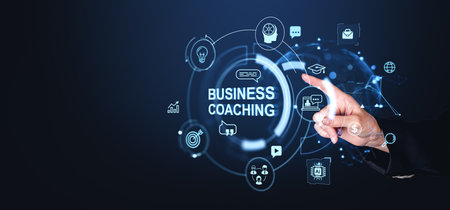 A hand interacts with a business coaching interface, displaying various icons and symbols on a dark background, representing digital innovation and education conceptsの写真素材