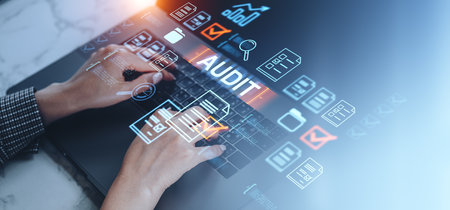 Businesswoman hands typing on laptop, virtual screen with audit and office documents hologram. Concept of quality control, data analysis and certificationの写真素材