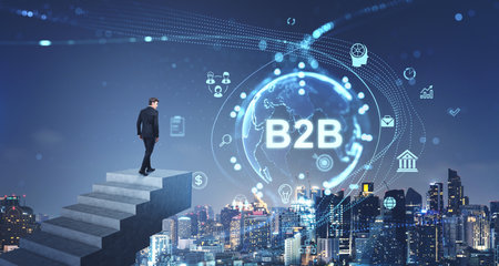 Businessman climbing stairs, city skyscrapers at night. B2b glowing earth hologram hud with icons. Concept of financial success, international marketing, business to business and e-commerceの写真素材