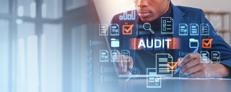 Business professional conducting a digital audit. Holographic icons of documents, checkmarks, and magnifying glasses overlay the image. Corporate audit conceptの写真素材