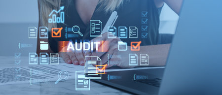 Businesswoman working on an audit with hologram icons of documents and checkmarks. Futuristic and modern business concept on a light blue backgroundの写真素材