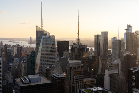 A stunning aerial view of Manhattan's skyline at sunset, showcasing modern architecture against a...