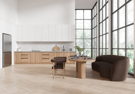 Modern kitchen interior featuring light wood cabinetry, a dining table, and brown seating, with large windows and natural light. 3D Renderingの写真素材