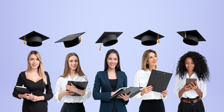 Five multiracial businesswomen portraits in row with clipboard and devices. Dreaming and smiling students with graduation cap above heads. Concept of career development, education and degreeの写真素材