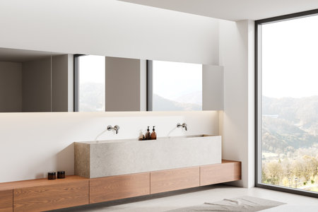 Corner view of hotel bathroom interior with double sink, stone shelf with accessories and long mirror on white wall. Panoramic window on countryside. 3D renderingの写真素材